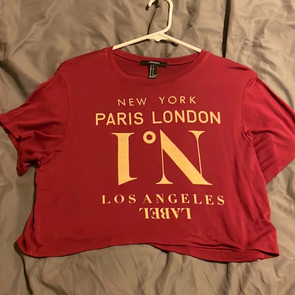 Lightweight red forever 21 crop top with cream colored wording on front.